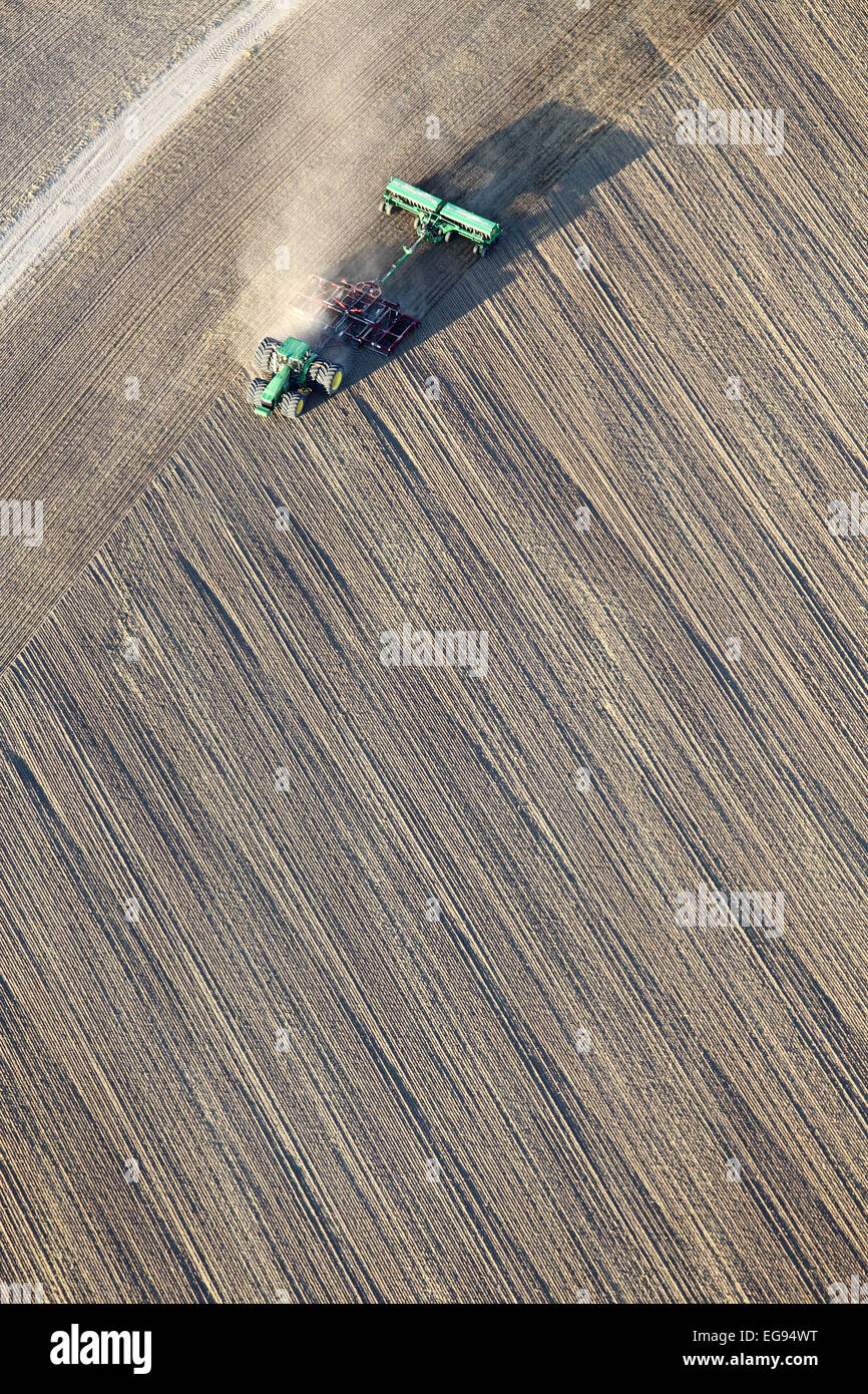 An aerial view of a farmer planting wheat in the fertile farm fields Idaho. Stock Photo