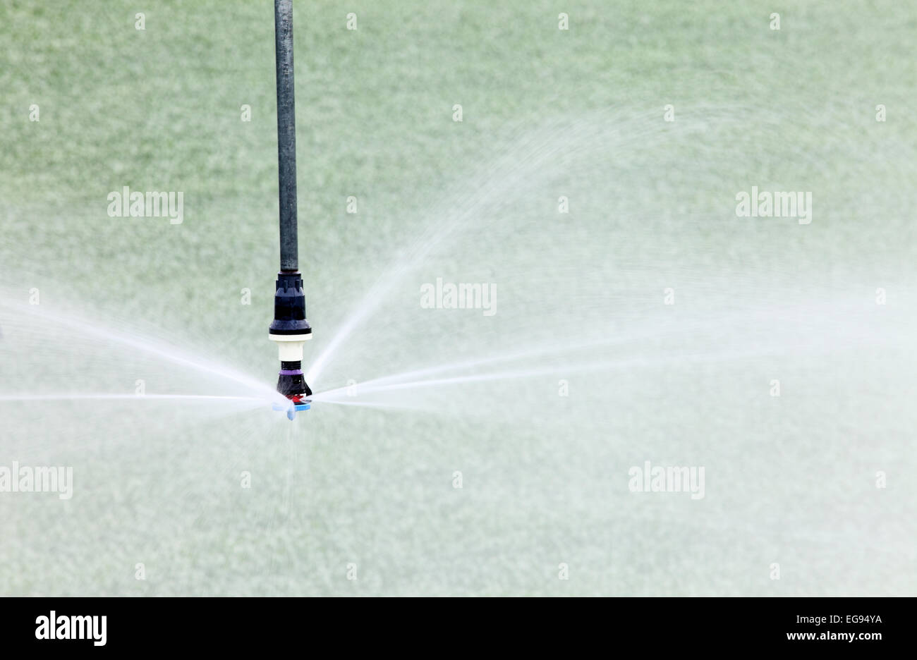 A closeup view of a high tech water conserving agricultural sprinkler head for irrigating farm crops. Stock Photo