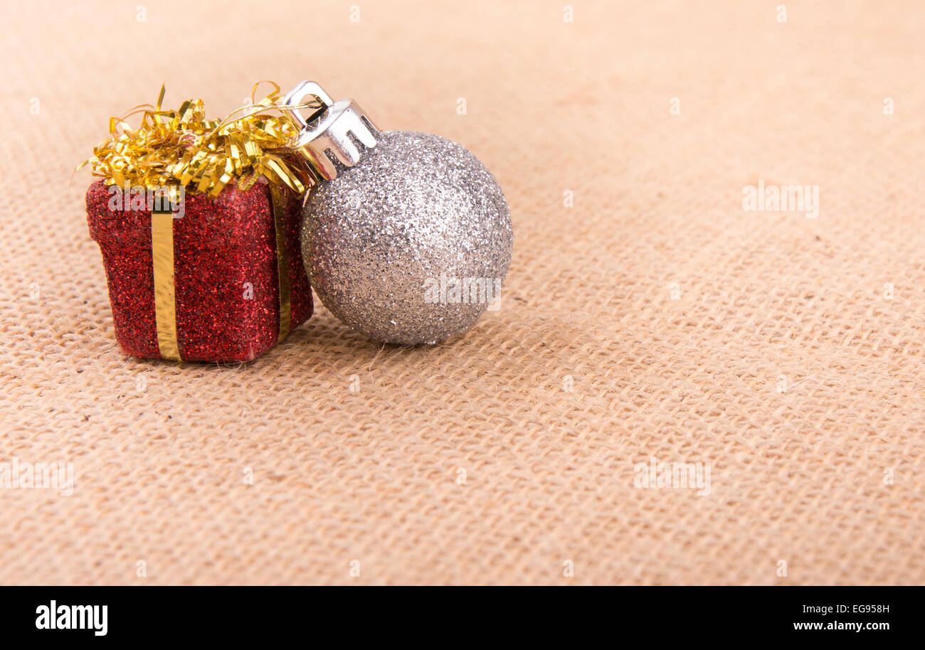 Two Christmas ornaments on burlap, a simple design with old time feel Stock Photo
