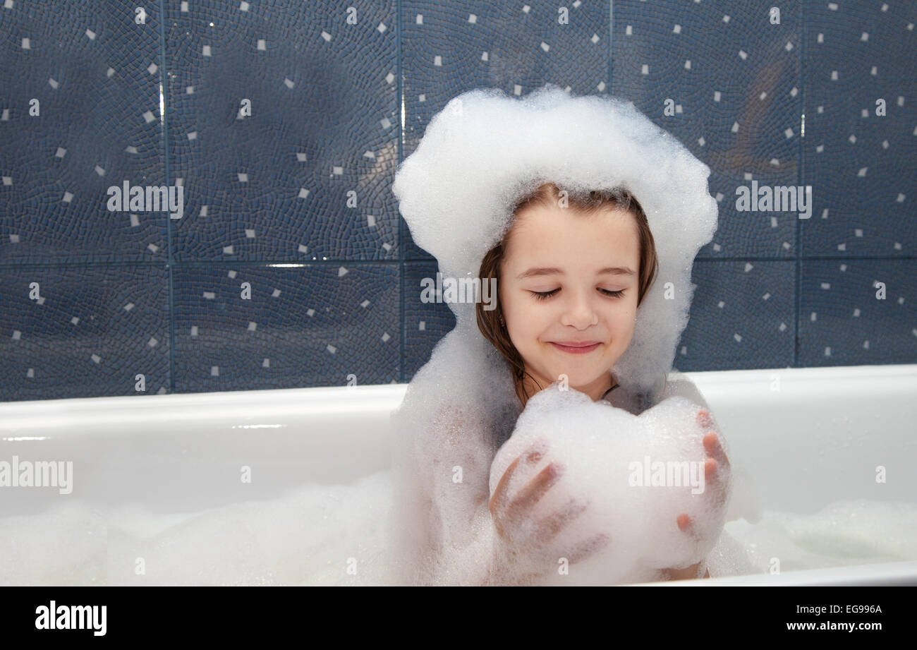 little girl playing with soap suds in a bath closeup Stock Photo Alamy