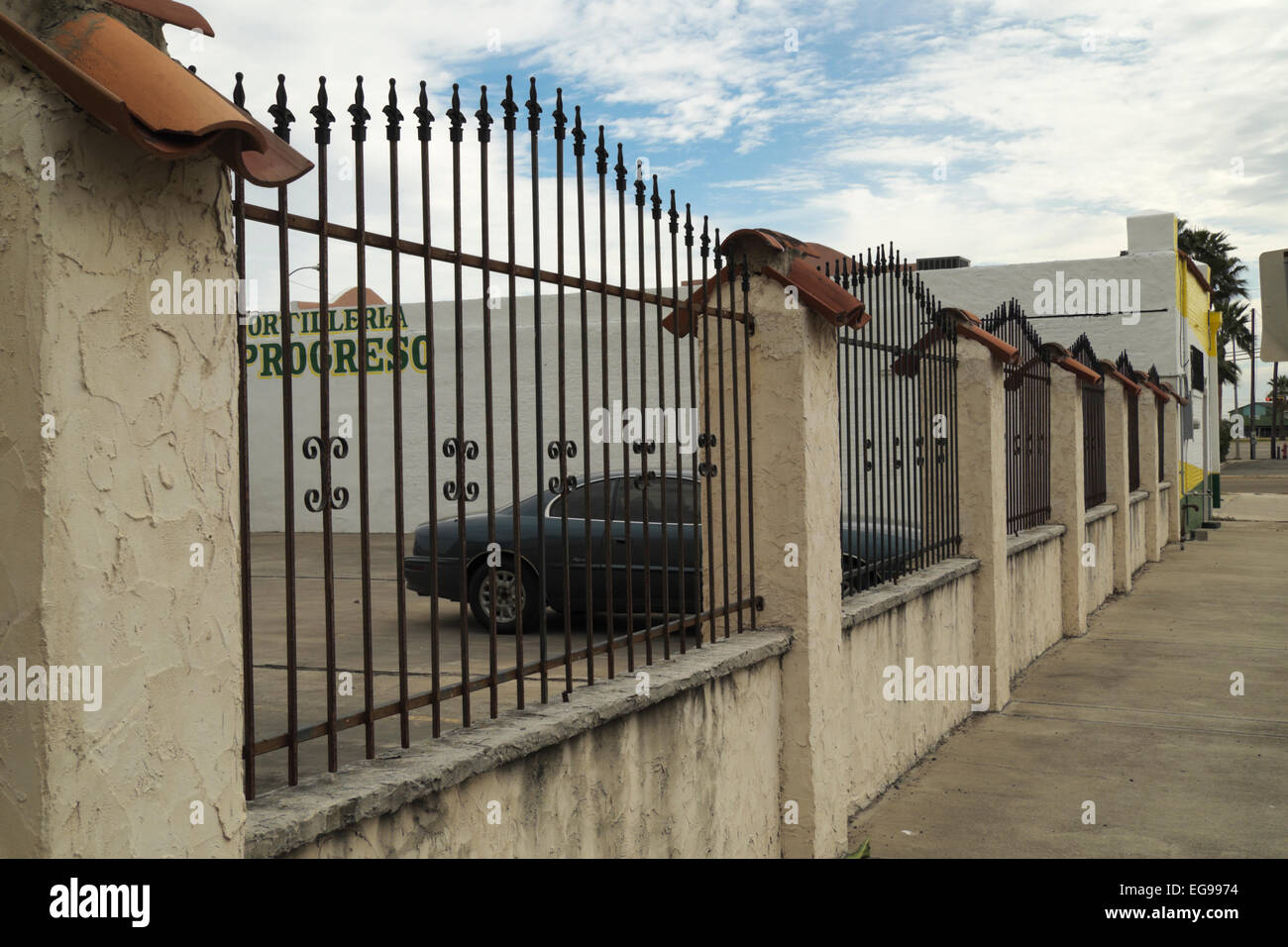 Concrete and wrought iron fence in downtown Weslaco, Texas, USA Stock