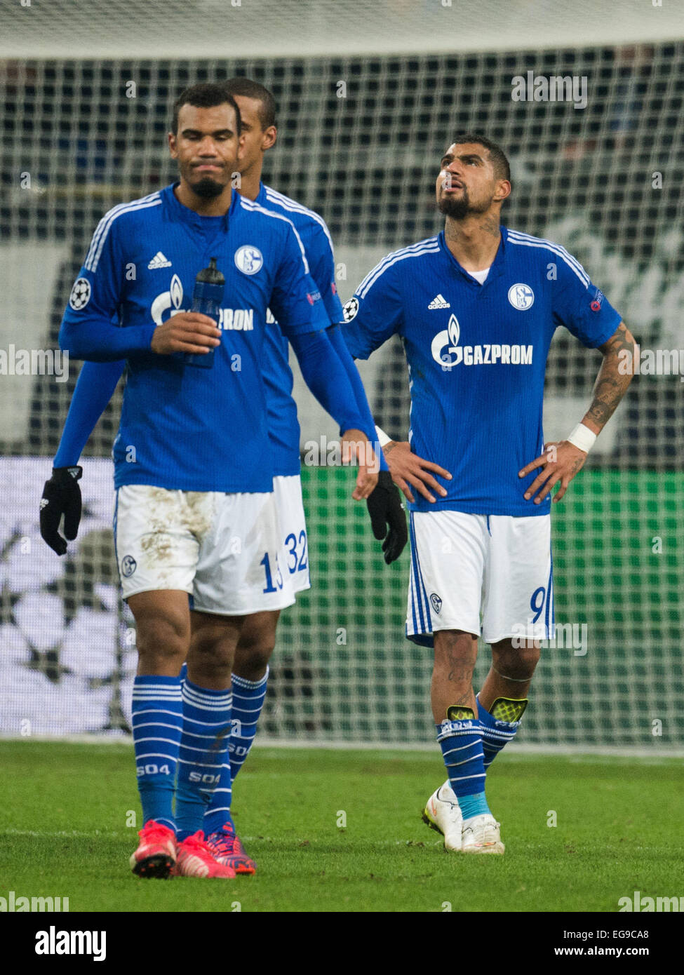 Schalke's Eric Maxim Choupo-Moting (l-r), Joel Matip and Kevin-Prince Boateng walk off the pitch after the Champions League Round of 16 soccer match FC Schalke 04 vs Real Madrid in Gelsenkirchen, 18 February 2015. Photo: Bernd Thissen/dpa Stock Photo