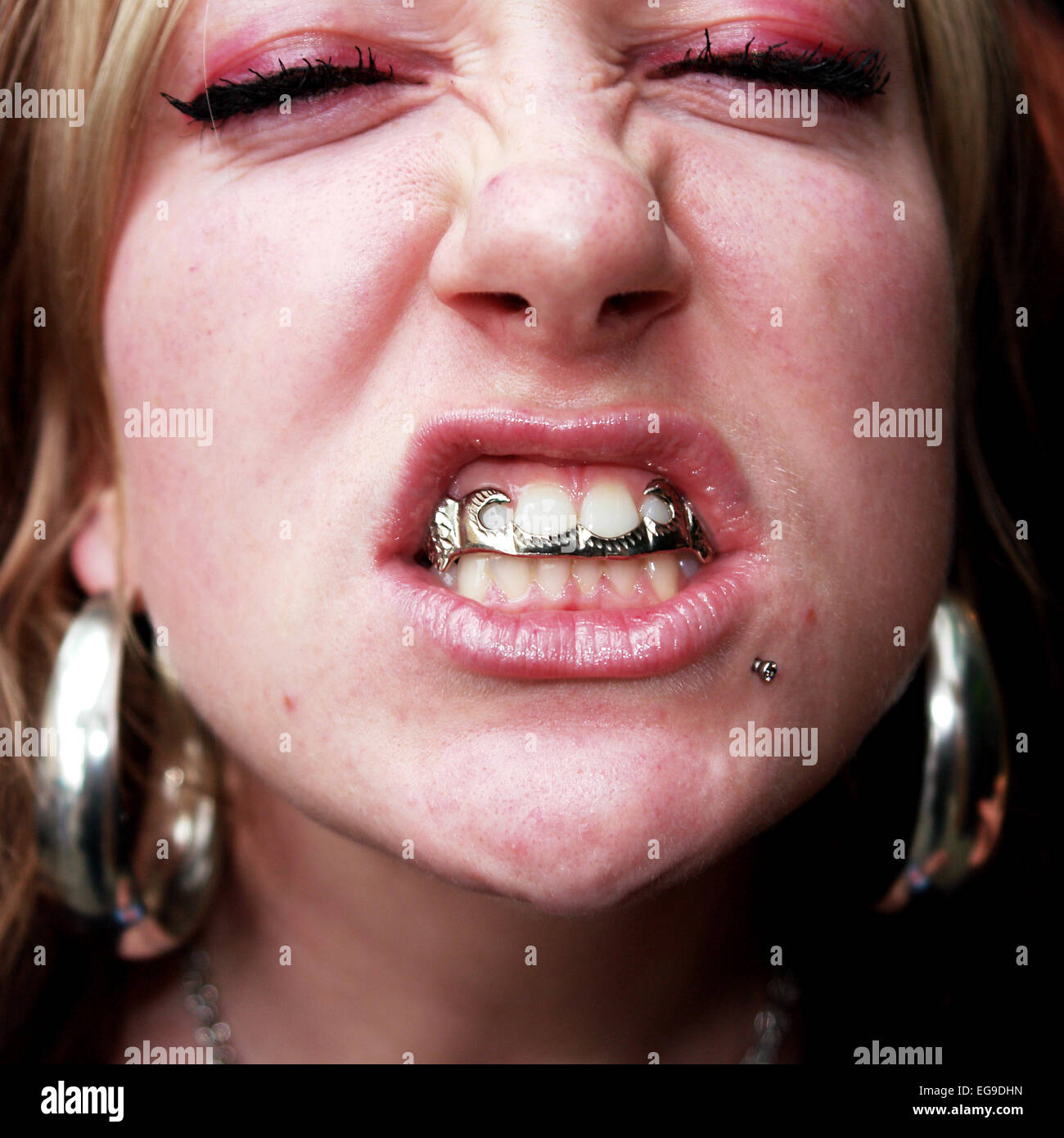 Portrait of a Woman wearing a dental grill Stock Photo