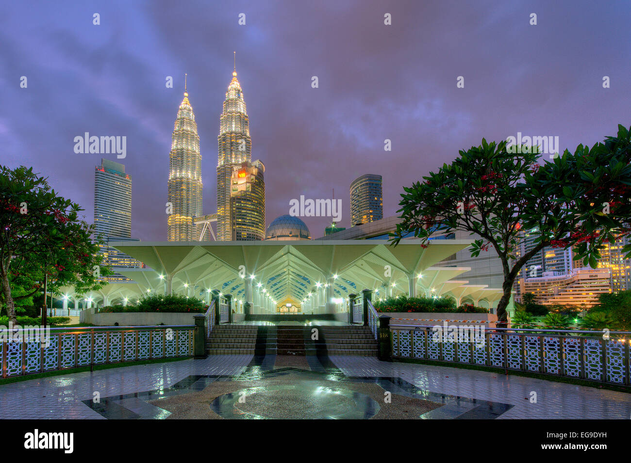 Malaysia, View of illuminated As-Syakirin Mosque (Masjid As Syakirin) and Kuala Lumpur in background Stock Photo