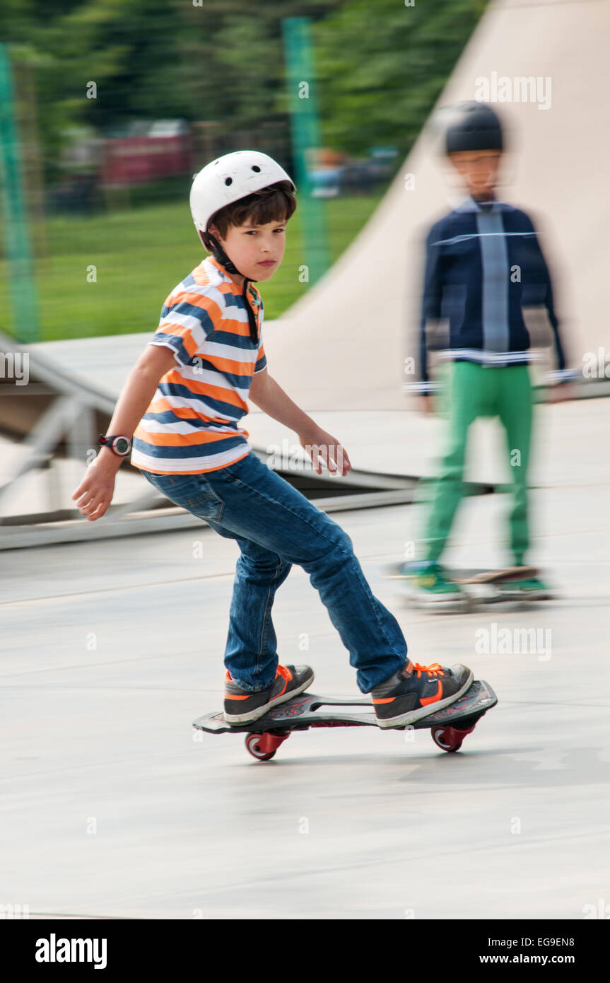Boy (8-9) riding a skateboard Stock Photo