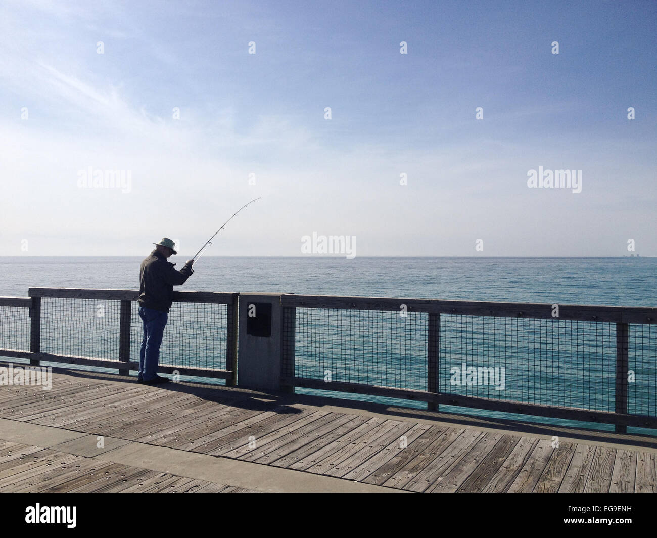 Man in pier fishing Stock Photo Alamy