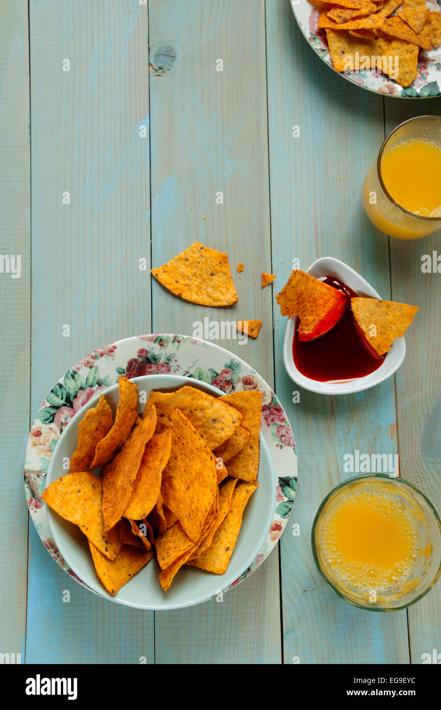 Bowl of potato chips, sauce and juice on table Stock Photo Alamy