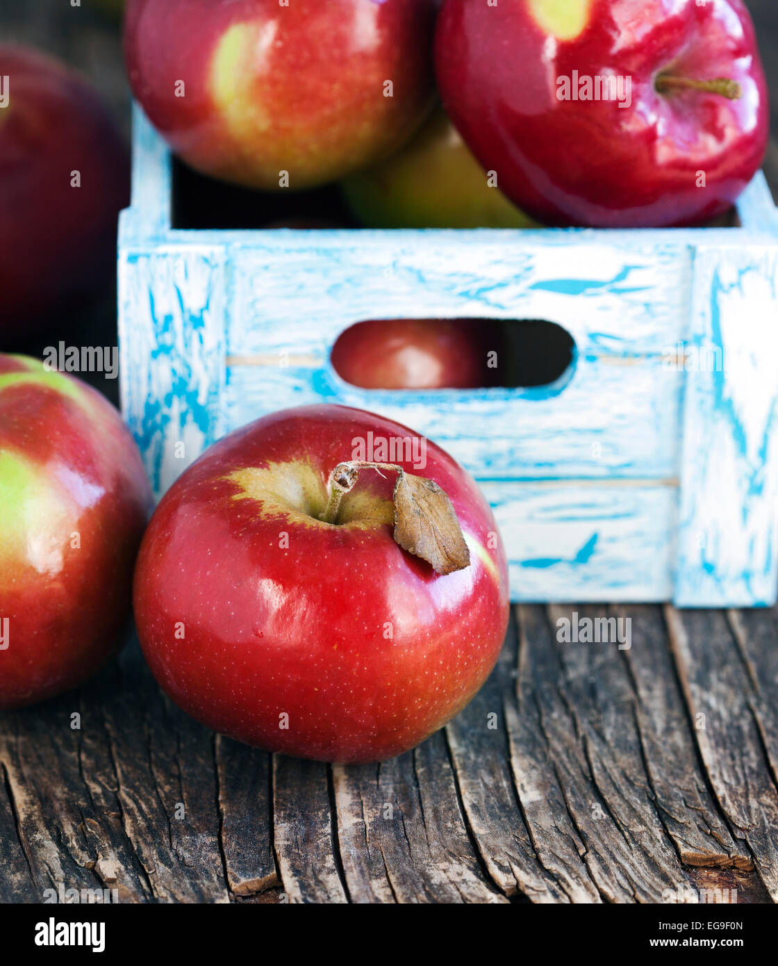 Red apples in wooden crate Stock Photo