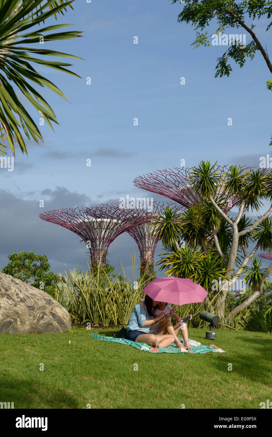 Mother and daughter sitting under a parasol in Gardens by the Bay, Singapore  Stock Photo - Alamy