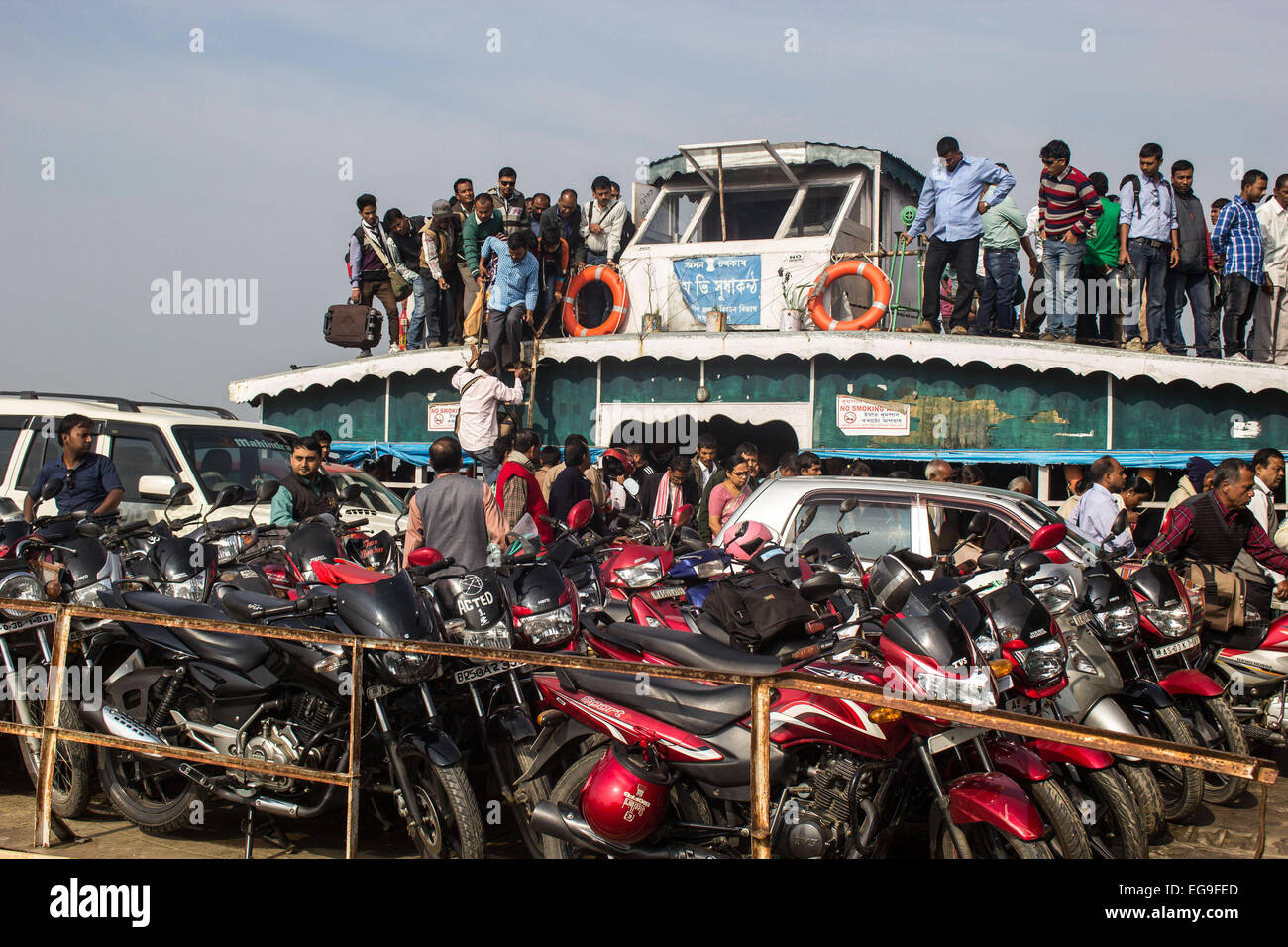 Jorhat, Assam, India. 20th Feb, 2015. An overcrowded ferry with passengers and vehicles on the Brahmaputra River near Majuli river island in Jorhat district of northeastern Assam state on February 20, 2015. Ferries in developing countries are often old vessels, sometimes repurposed to operate in waterways for which they weren't designed. They are often overcrowded, which can throw off a boat's balance or make it top heavy and more prone to capsizing. Credit:  Luit Chaliha/ZUMA Wire/ZUMAPRESS.com/Alamy Live News Stock Photo