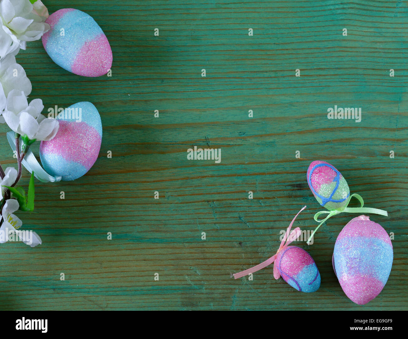Colorful decorative easter eggs and branch with spring flowers on the ...