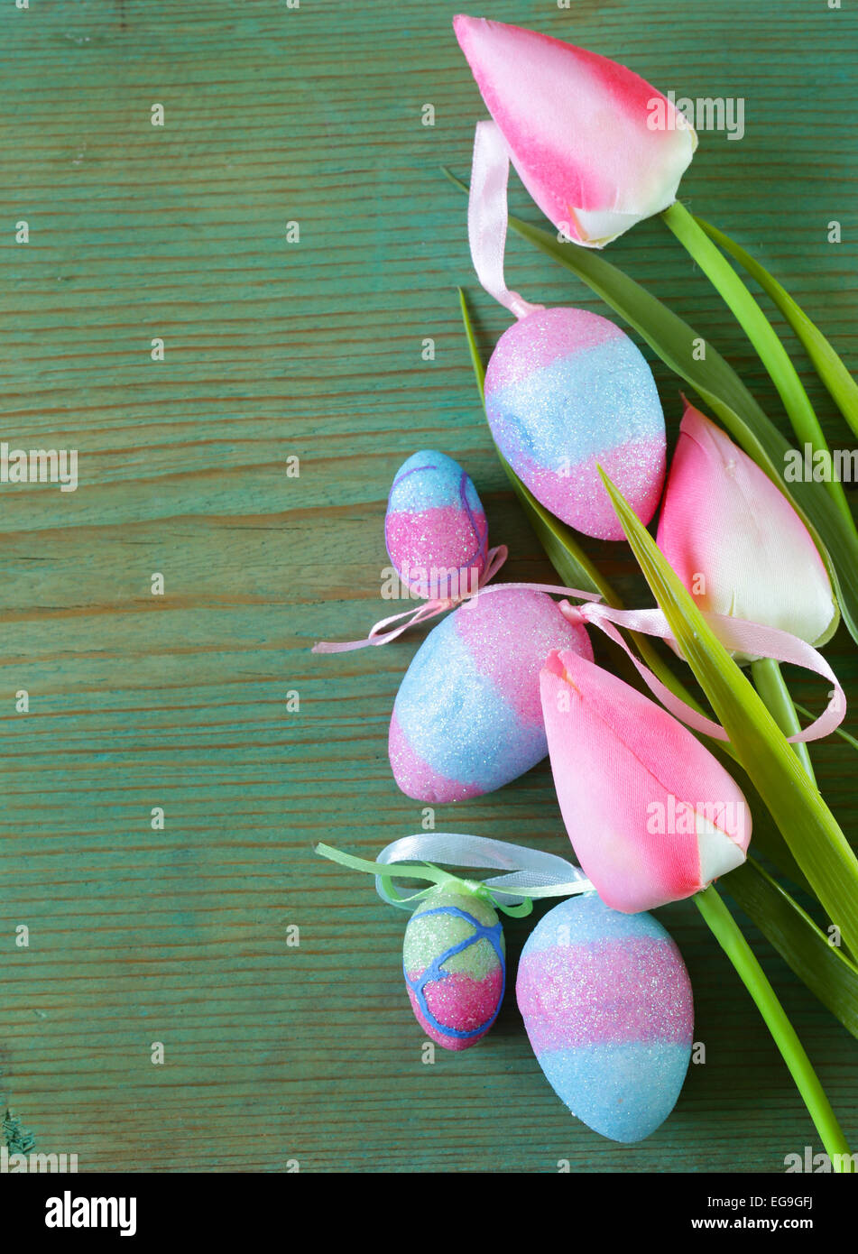 Colorful decorative easter eggs and branch with spring flowers on the ...