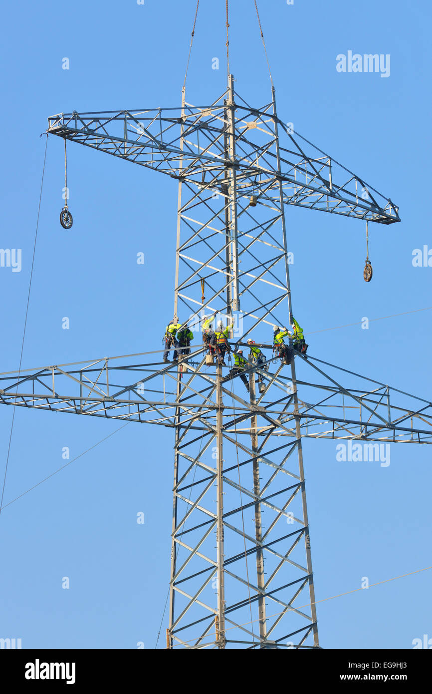 Overhead linemen working on a pylon, Waiblingen, Baden-Württemberg, Germany Stock Photo