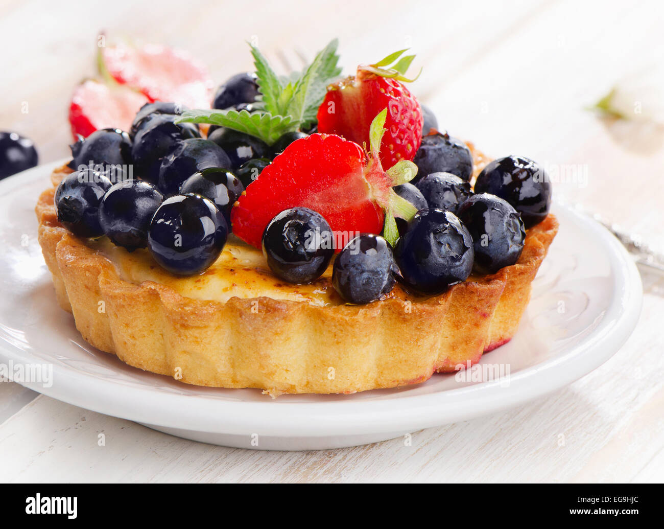 Fresh blueberry tart on  white plate. Selective focus Stock Photo