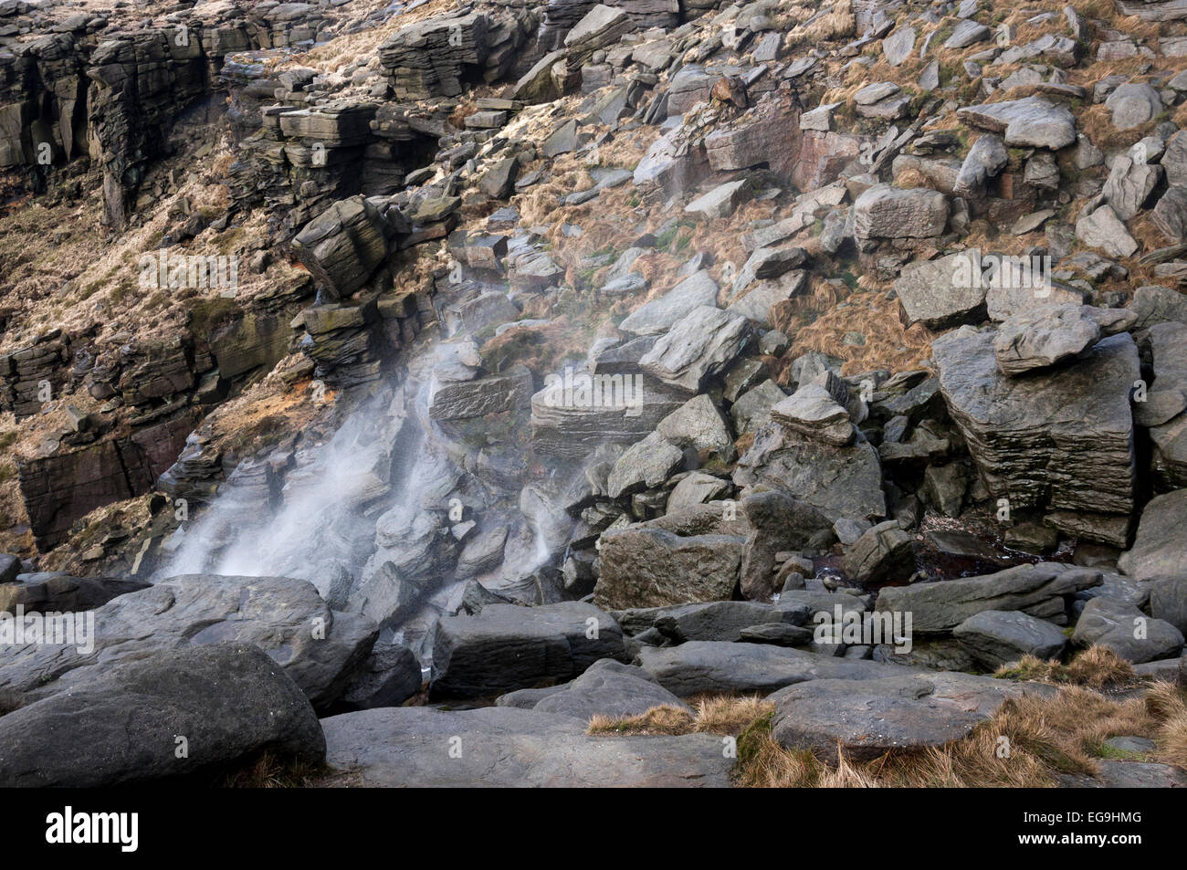 Kinder downfall on a windy day with water being blown up over the rocks. Kinder Scout in the High Peak. Stock Photo