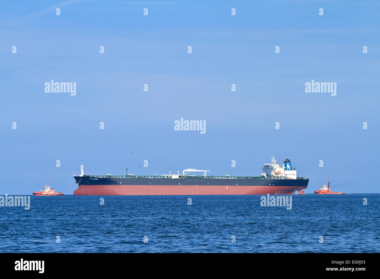 Tug boat guiding ship hi-res stock photography and images - Alamy