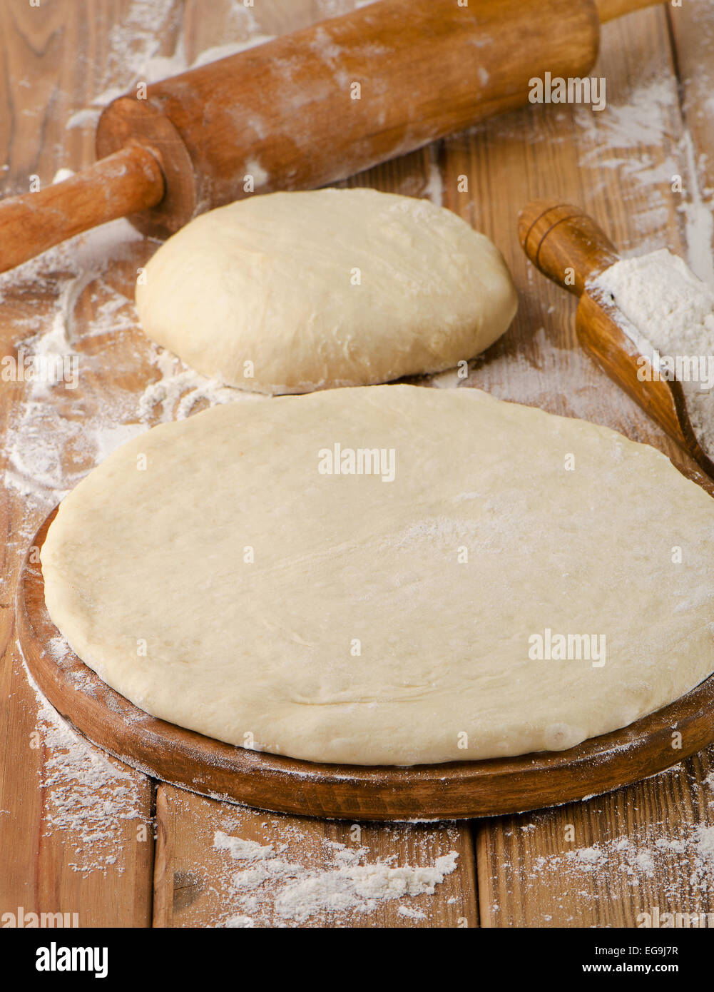 pizza dough on a wooden background. selective focus Stock Photo