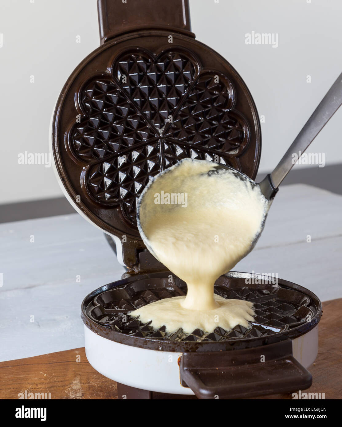 Homemade waffles are cooked in a waffle iron Stock Photo