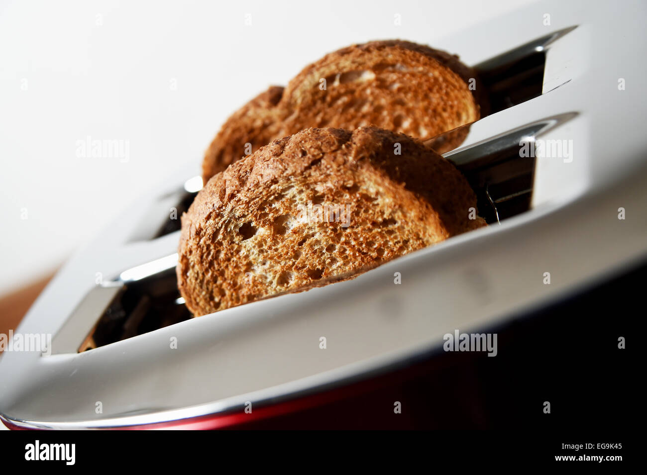 Electrical toaster in kitchen with cooked toast made from brown bread Stock Photo Alamy