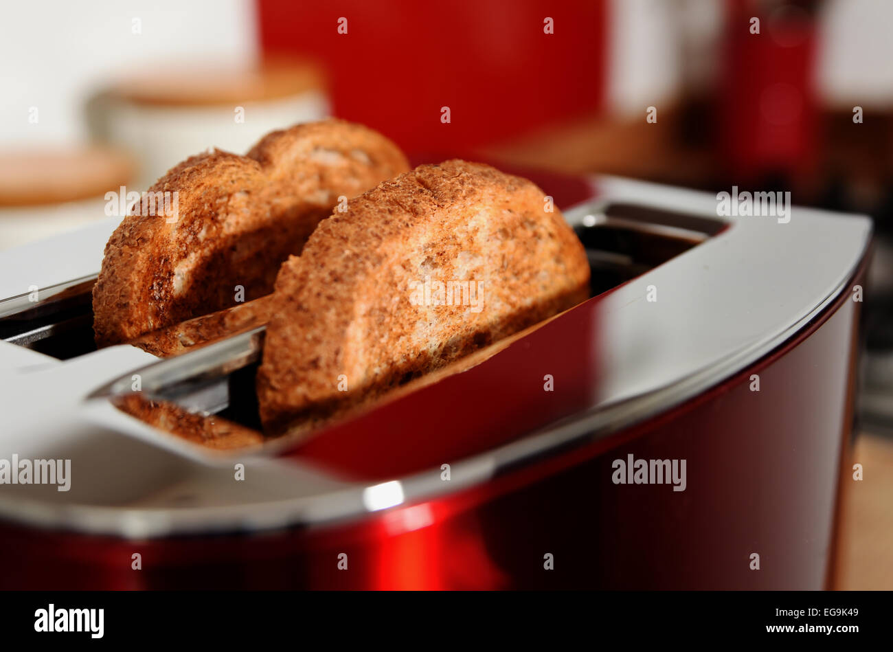 Electrical toaster in kitchen with cooked toast made from brown bread Stock Photo Alamy