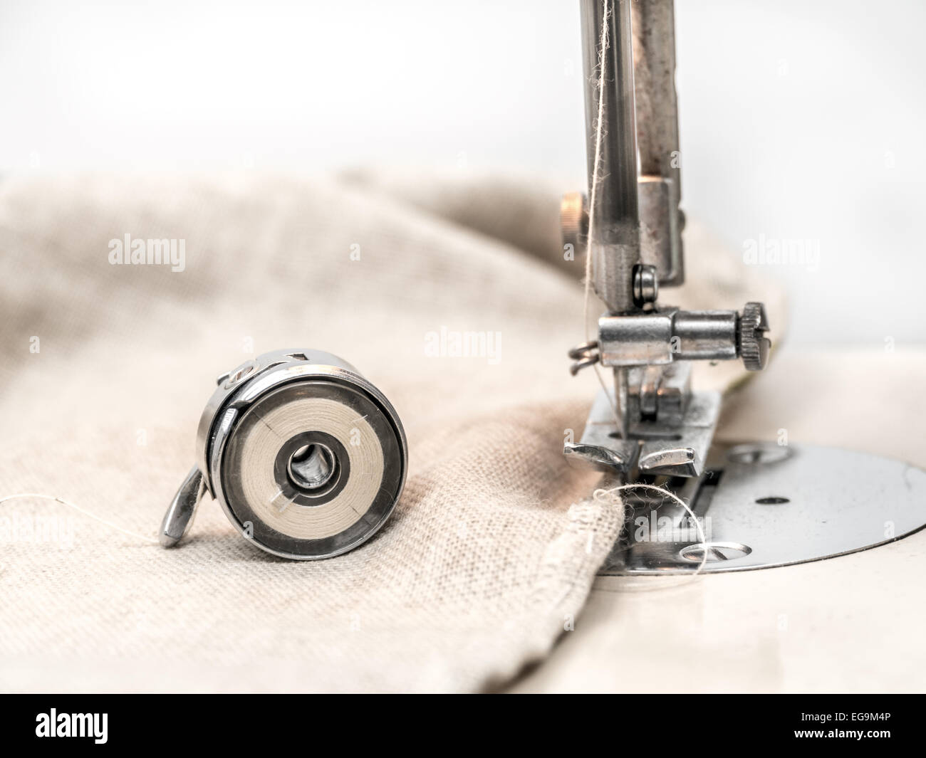 Closeup of fabric border under sewing machine head and thread cassette Stock Photo