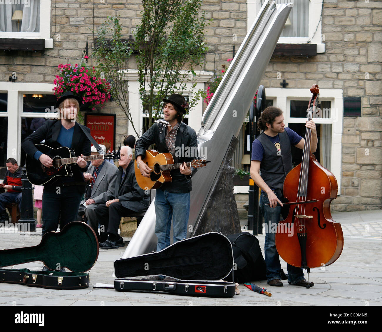 Band playing outdoors in the main square in Haworth, a popular tourist village in the heart of Bronte country in Yorkshire, UK. Stock Photo