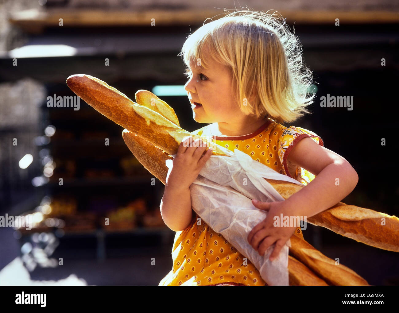 Young girl carrying French baguettes. France Stock Photo Alamy