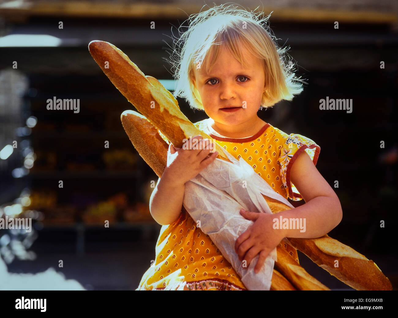 Young girl carrying French baguettes. France. Stock Photo