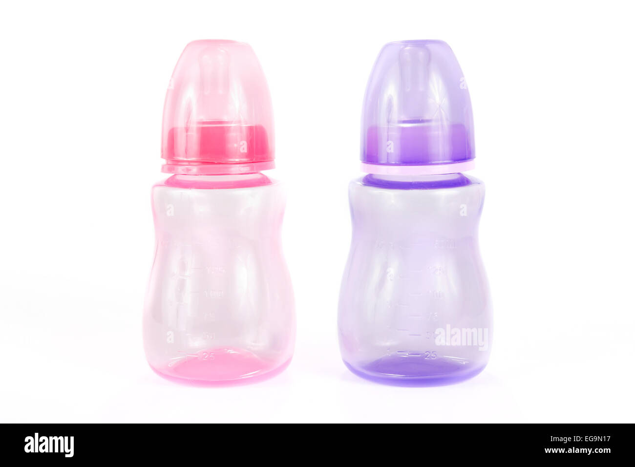 Pink and purple babies bottles over white Stock Photo