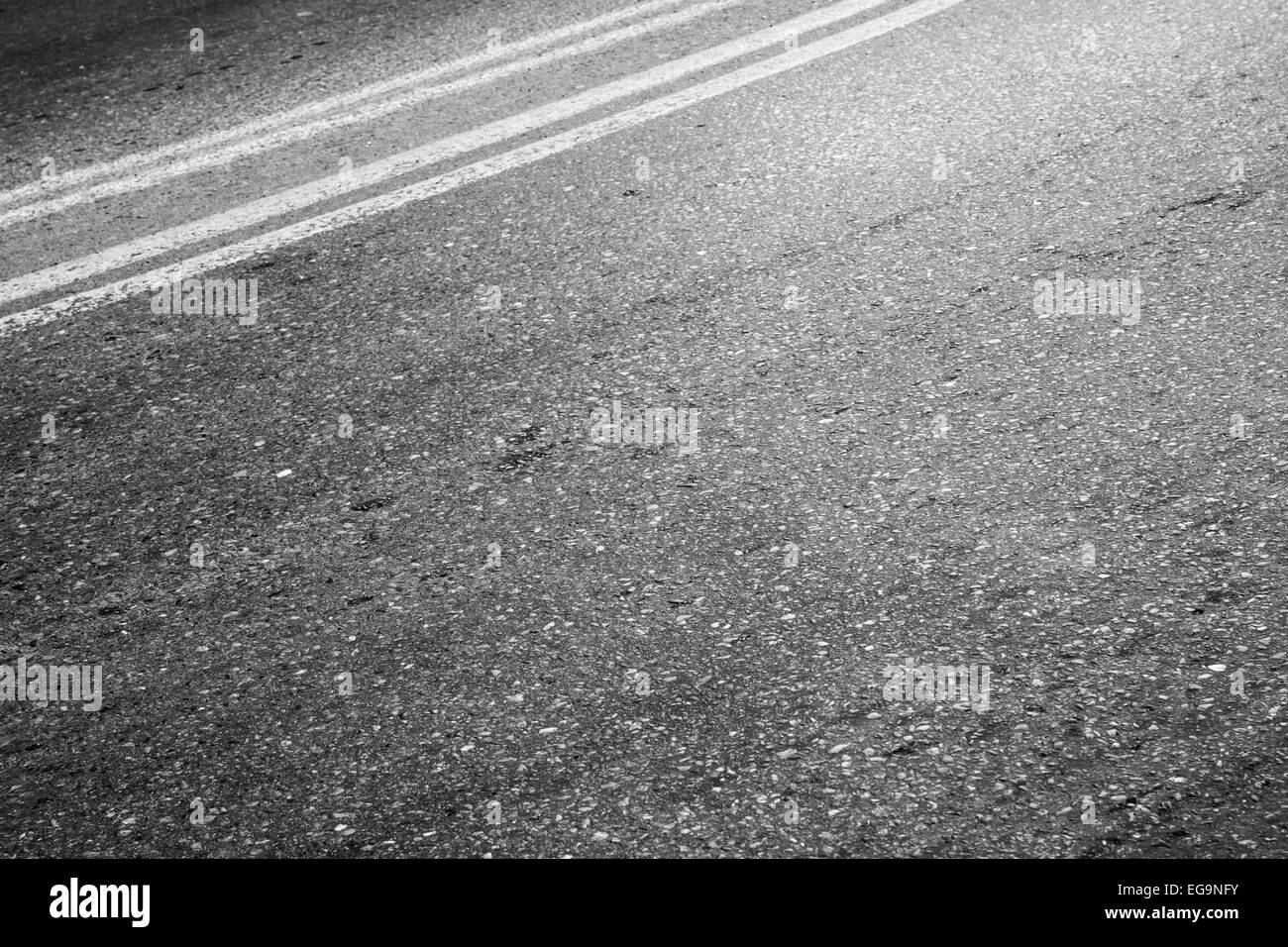 Abstract asphalt road fragment, automotive transportation background, double dividing line Stock Photo