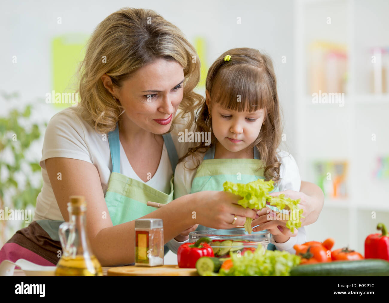 mom and kid preparing healthy food Stock Photo