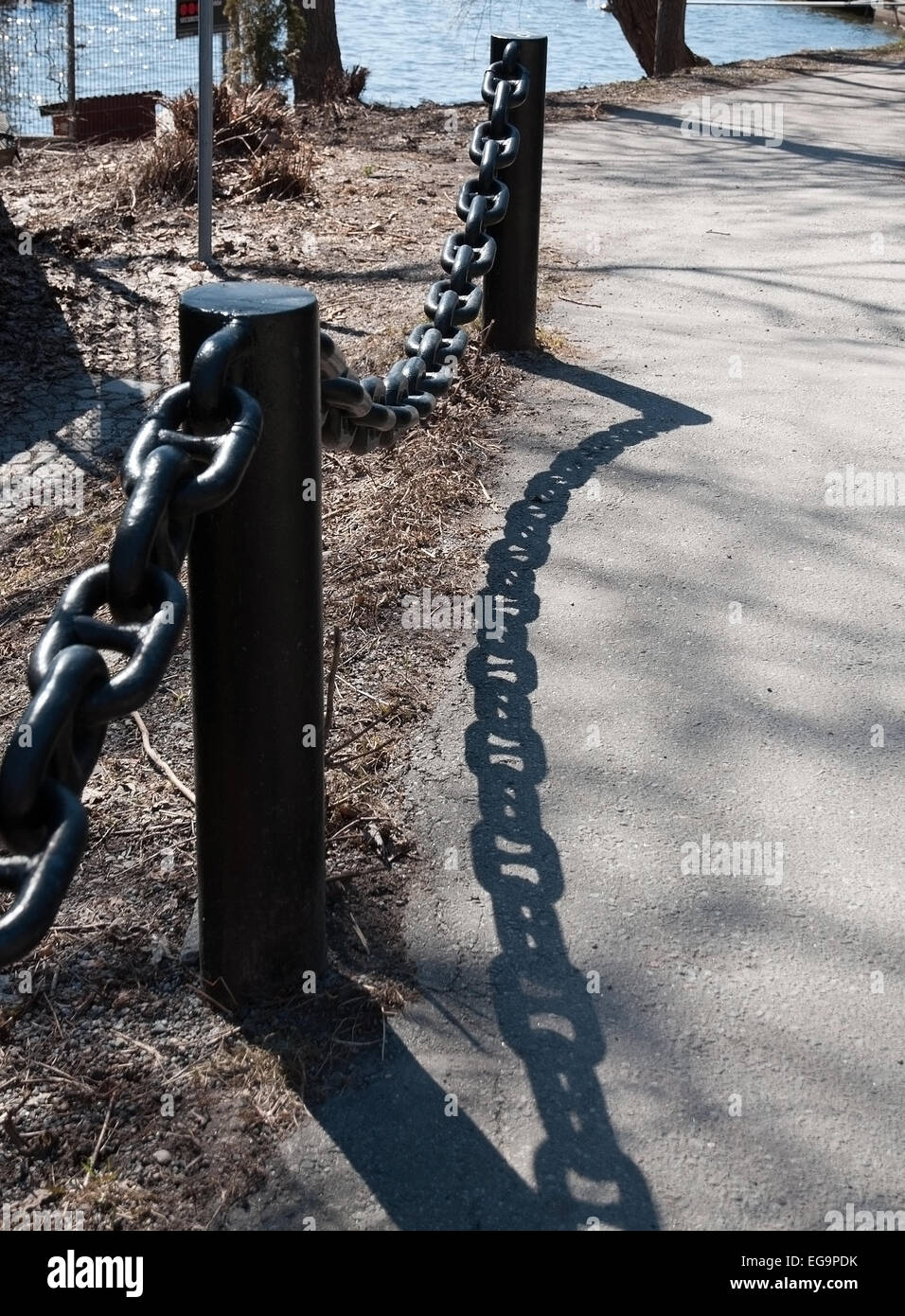Black chain fence with interesting shadow pattern, Solna, Sweden. Stock Photo
