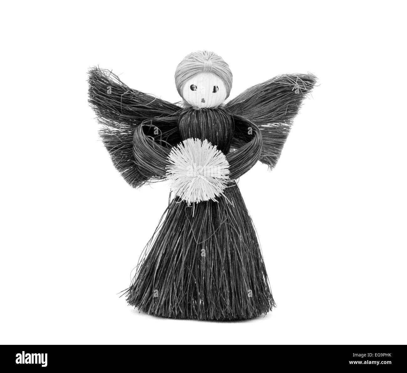 Handmade straw Christmas angel - festive decoration, isolated on a white background - monochrome processing Stock Photo