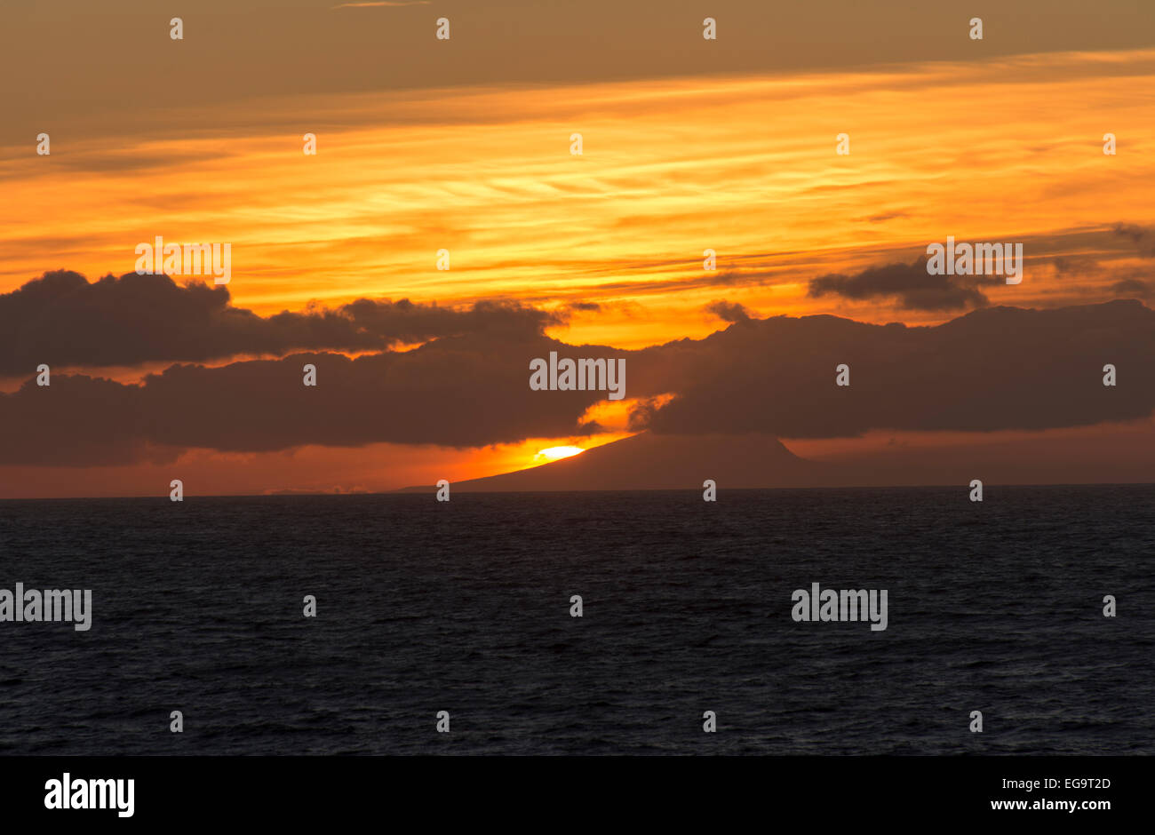 Sunset Deception Island Antarctica clouds colored orange Stock Photo