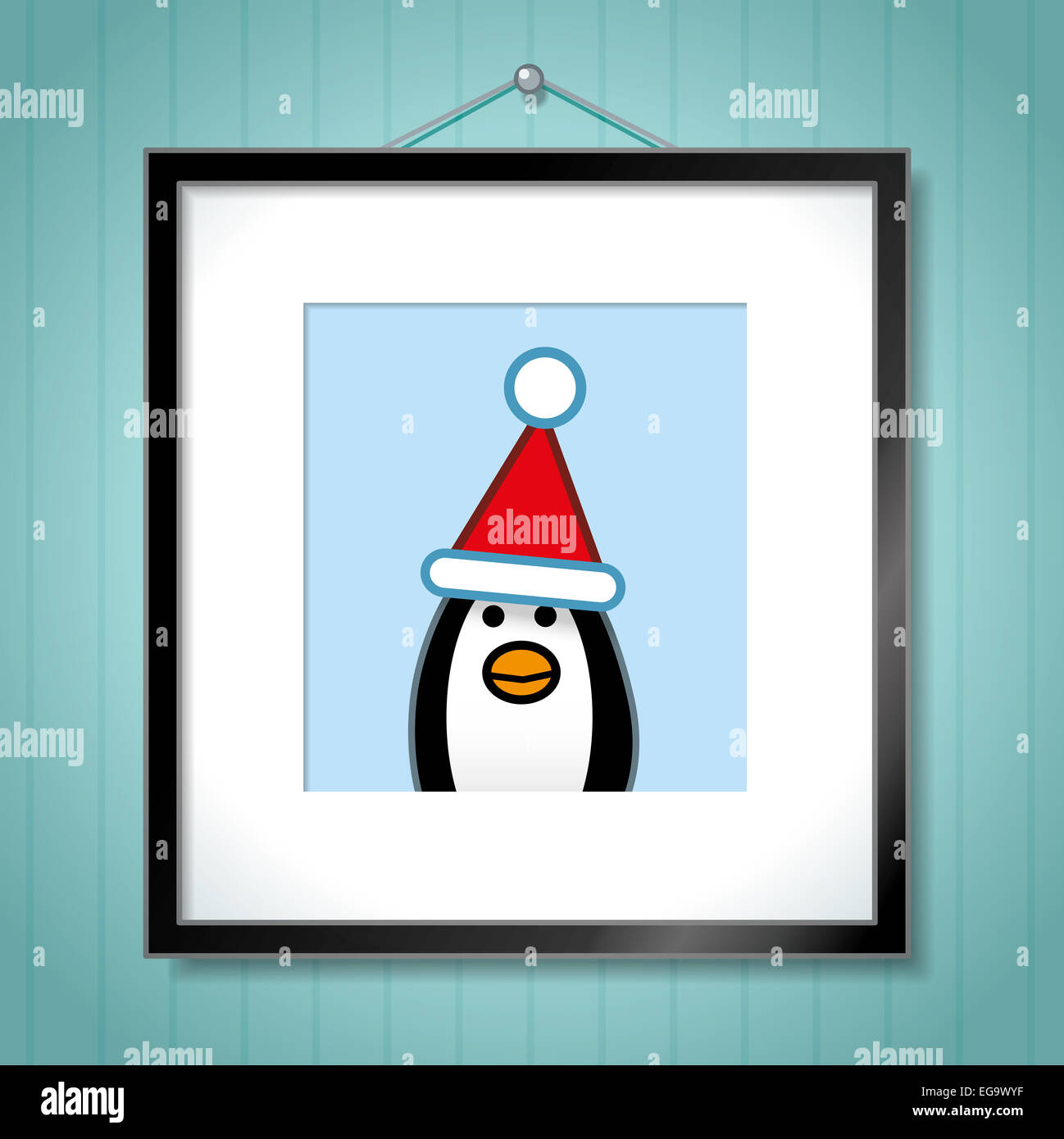 Cute Portrait of Single Penguin Wearing Santa Hat in Picture Frame Hanging on Blue Wallpaper Background Stock Photo