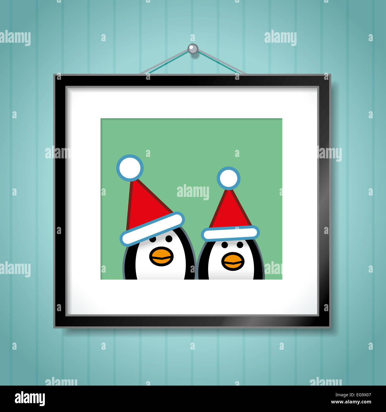 Cute Portrait of Penguin Couple Wearing Santa Hats in Picture Frame Hanging on Blue Wallpaper Background Stock Photo