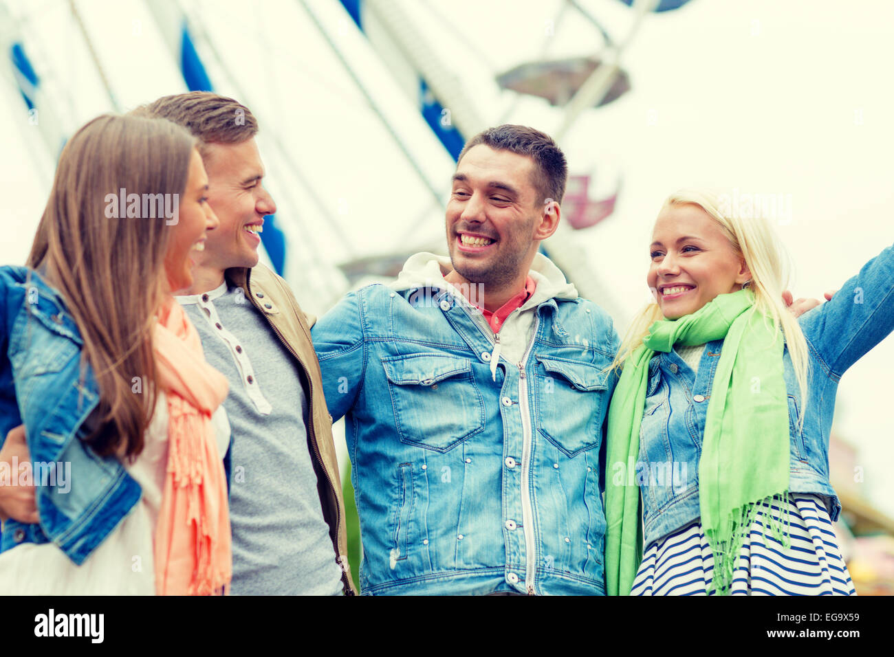 group of smiling friends in amusement park Stock Photo - Alamy