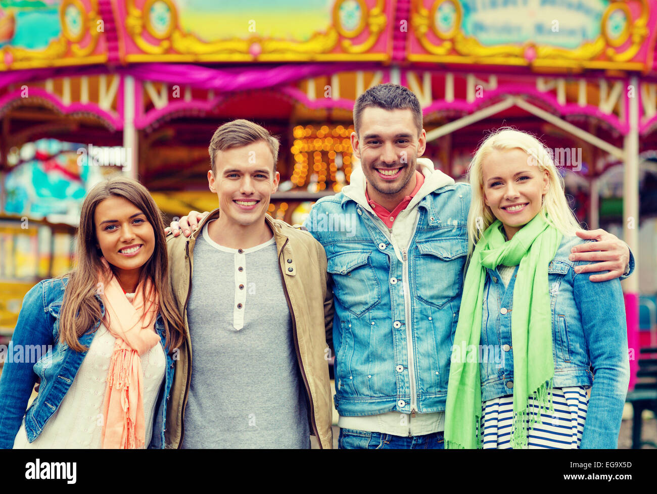 group of smiling friends in amusement park Stock Photo - Alamy