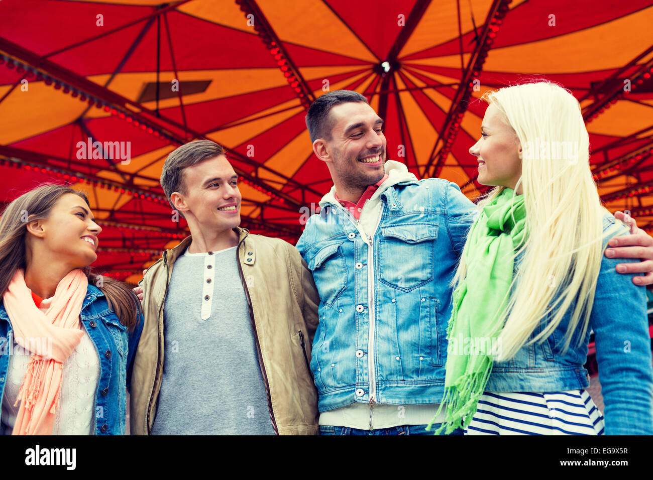 group of smiling friends in amusement park Stock Photo - Alamy