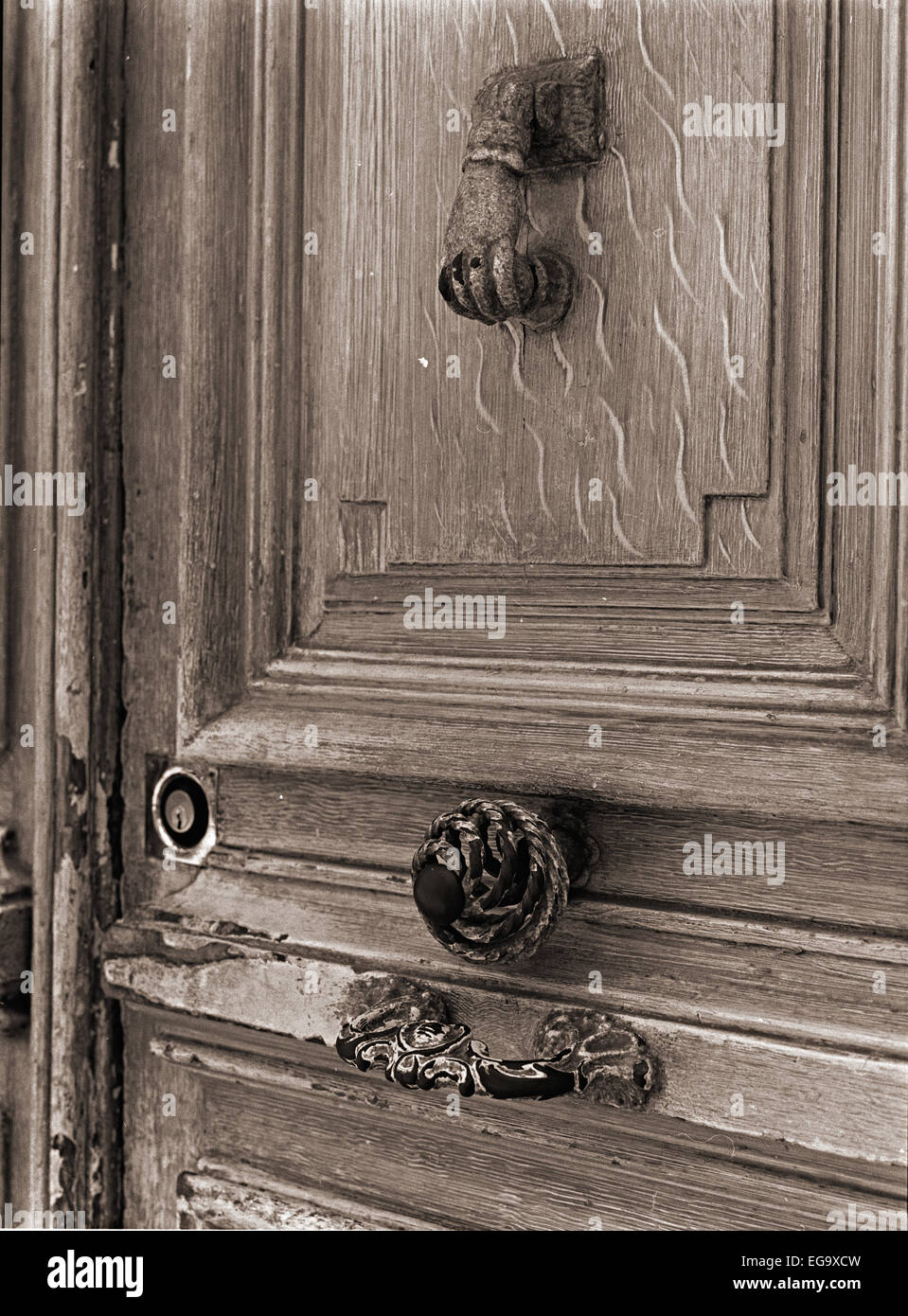 Monochrome medium format shot of a old door and hand shaped door handle