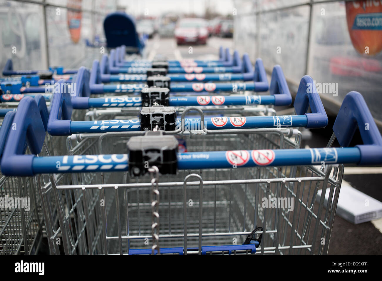 Tesco supermarket trolley in the car park of Tesco Extra Stock Photo