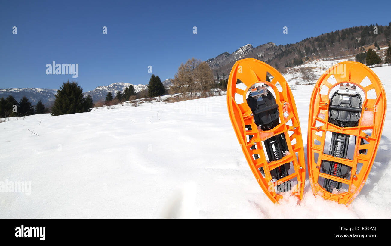 pari of orange modern snowshoes in the mountain Stock Photo