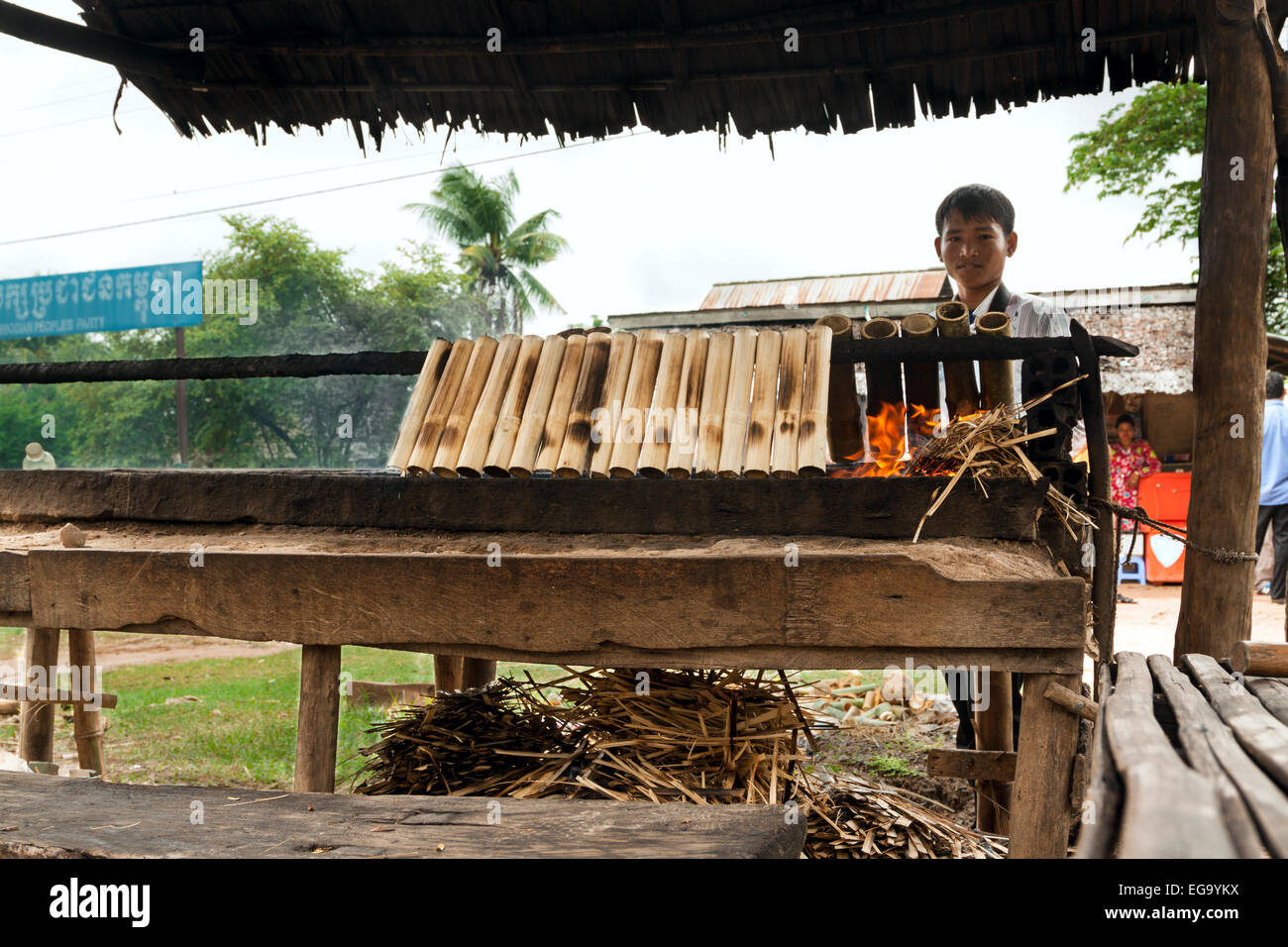 Cambodian food specialty (Kralan) - Bamboo sticks filled with sticky rice beans and grilled over open fire. Stock Photo