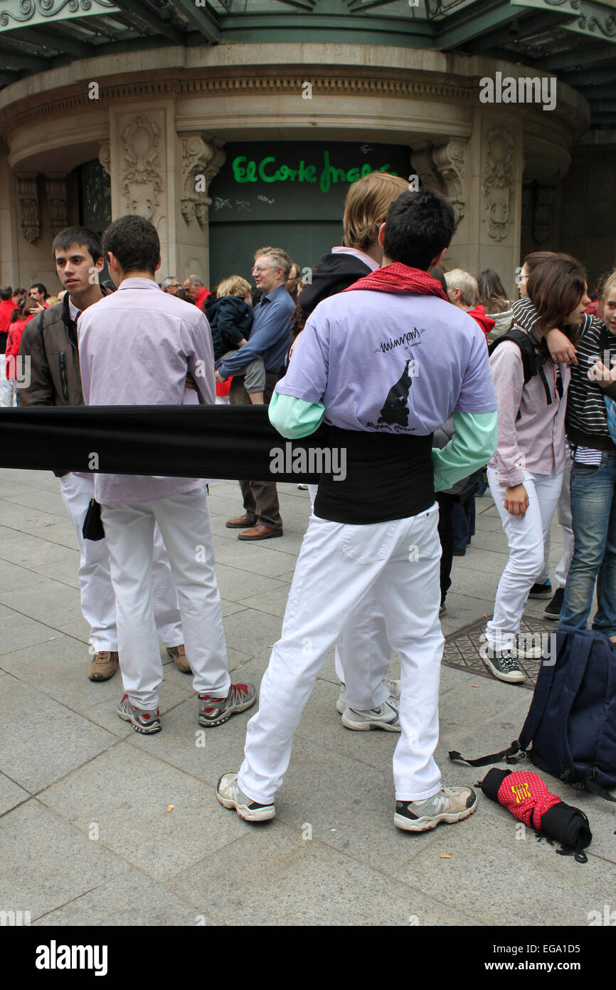 Boy putting on black sash for Castellers building human towers in Portal de l'Àngel, Barcelona, Catalonia, Spain Stock Photo