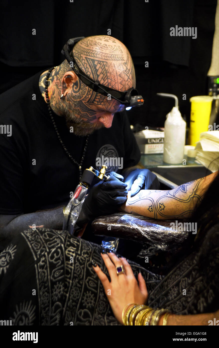 Brighton, UK. 20th February, 2015. Tattoo artist Matt Black at work the 8th Brighton Tattoo Convention Stock Photo