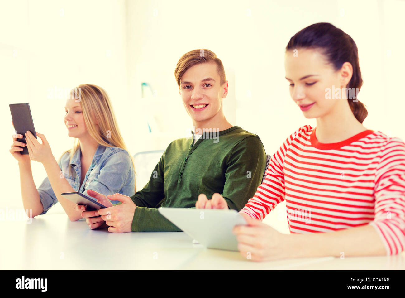 smiling students with tablet pc at school Stock Photo - Alamy