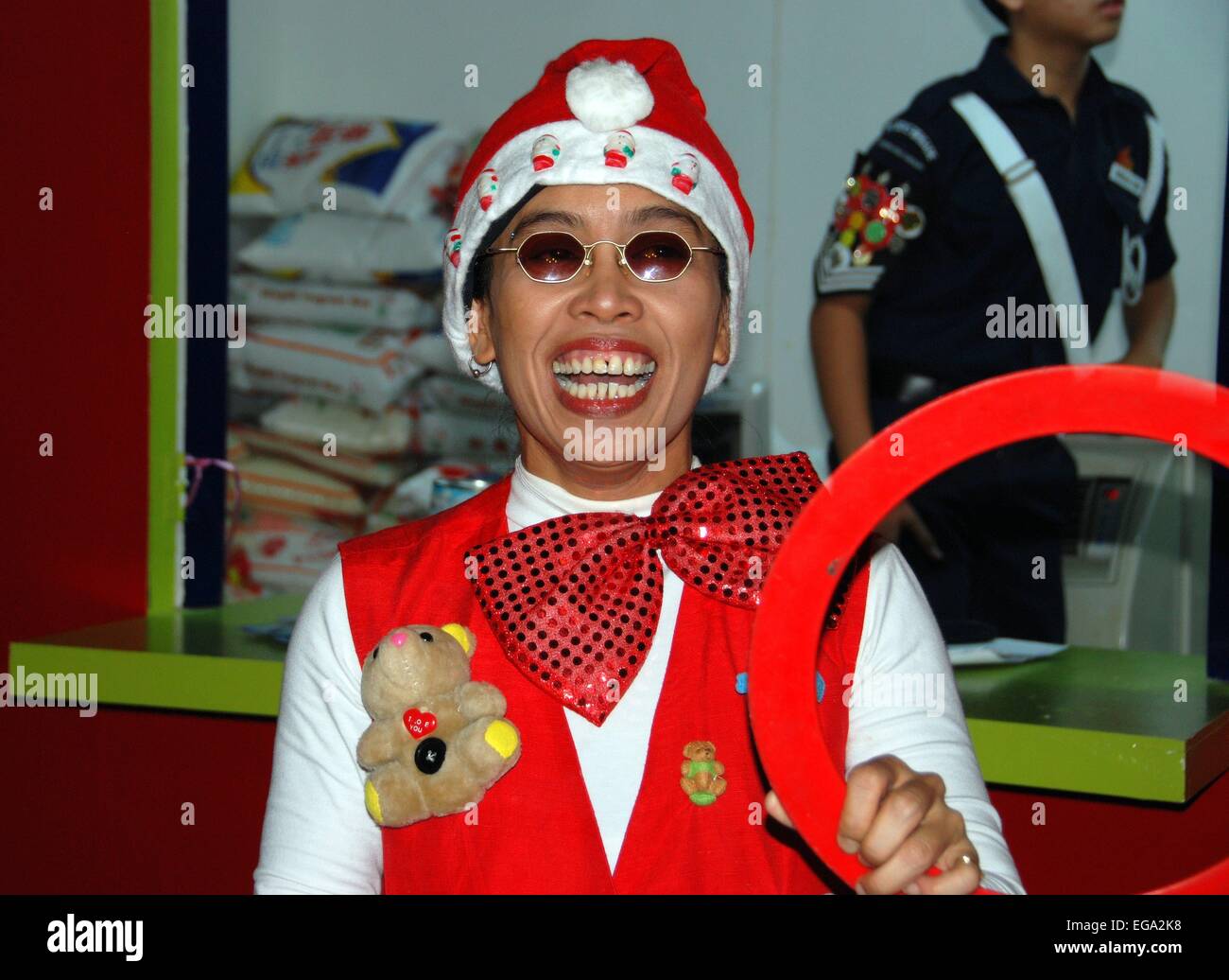 Singapore A street performer sporting a Christmas hat entertains