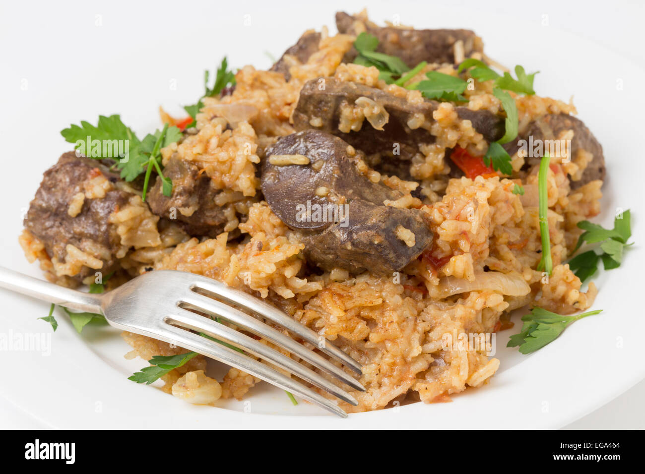 lightly fried lambs liver chunks baked on top of a pilaf of rice, onion, tomato, capsicum and dried currants in a chicken broth, Stock Photo