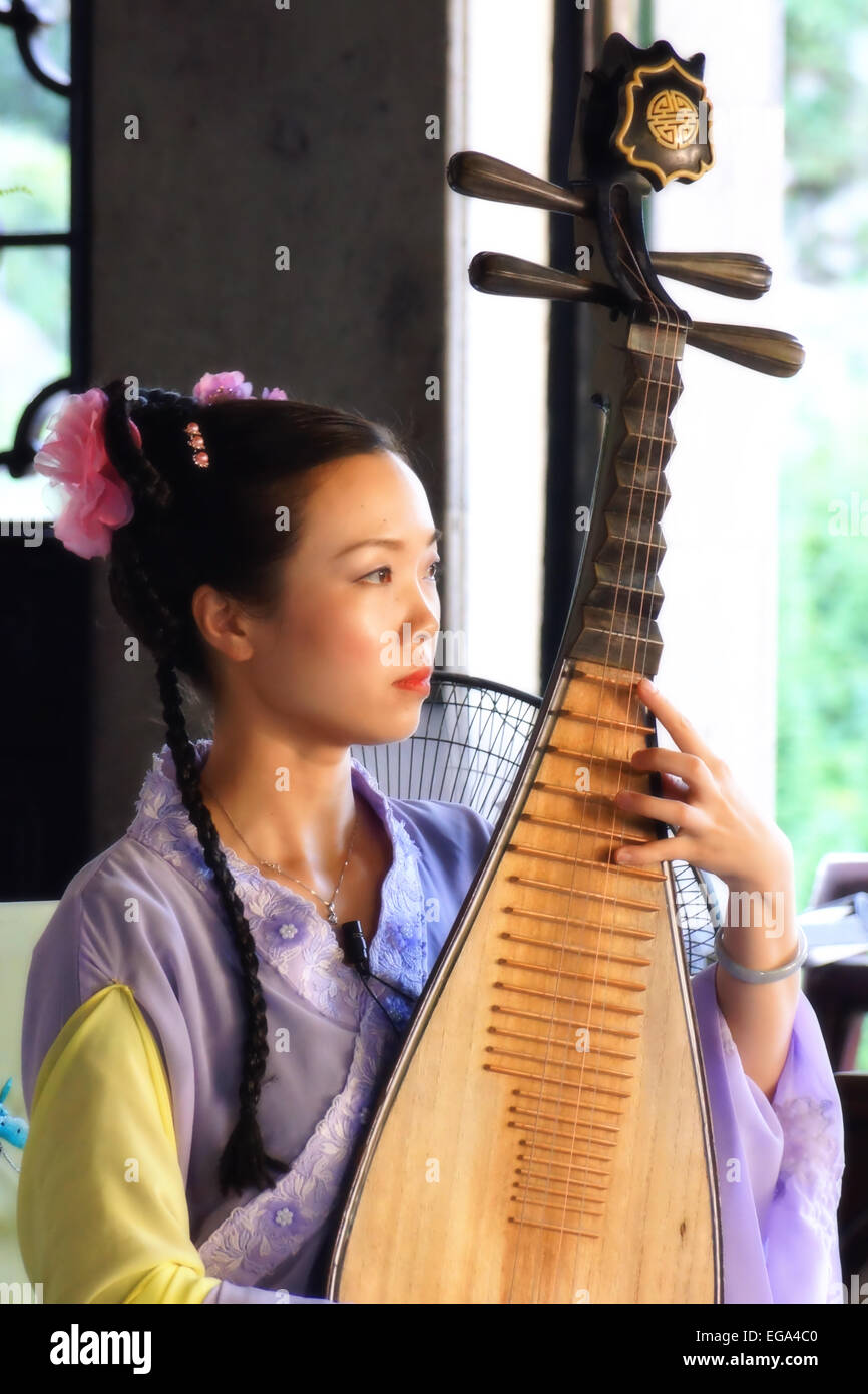 Chinese lady playing the Pipa or Chinese guitar Suzhou China