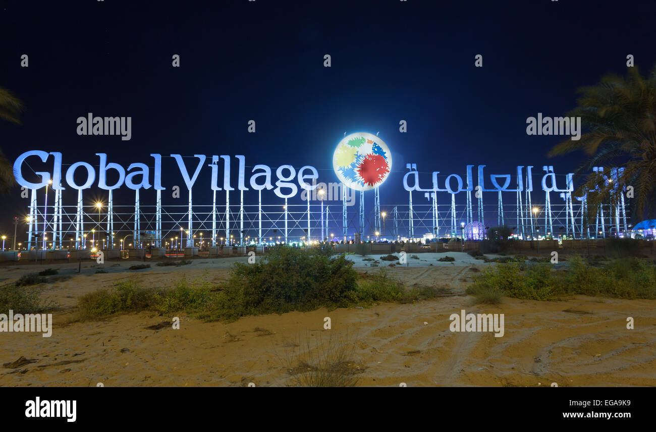 The Global Village sign illuminated at night Stock Photo Alamy